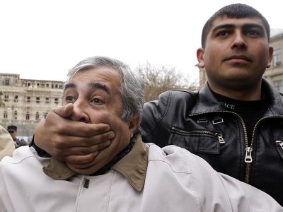 Офицер полиции в штатском задерживает активиста оппозиции, который призывает к свободе слова во время митинга в Баку, Азербайджан, 15 апреля 2010 года. Фото: David Mdzinarishvili / Reuters